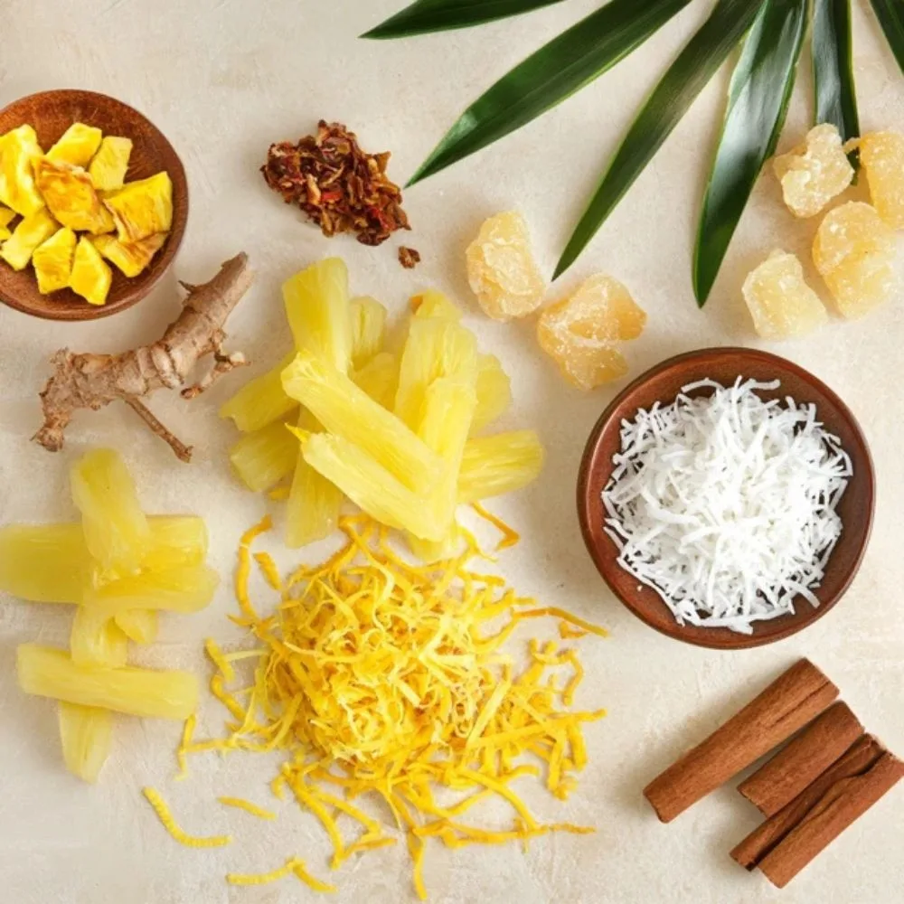 A Seasonal Variation Display With Lemon Zest, Dried Pineapple, And Warm Spices Near Coconut Candies, Bright Seasonal Colors.